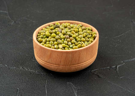 Green mung bean in wooden bowl on concrete backgroundの写真素材
