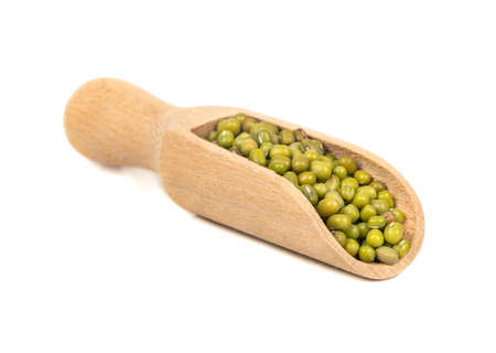 Dry green mung grains in wooden scoop on white backgroundの写真素材