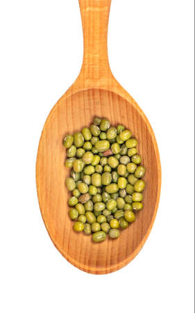Several green mung beans in a large wooden spoon on a white background, top viewの写真素材