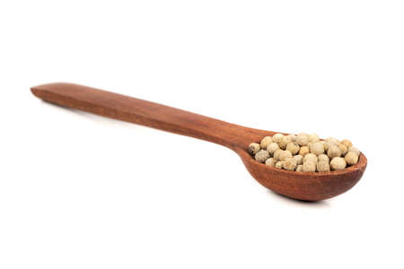 White pepper peas in wooden spoon on white backgroundの写真素材