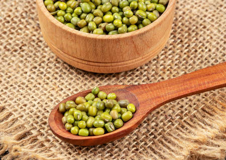 Grain green mash in a bowl and spoon close-up on the burlapの写真素材