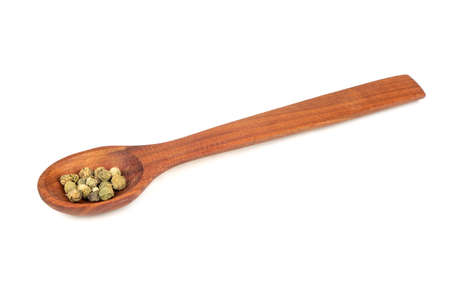 Green pepper peas in wooden spoon isolated on a white backgroundの写真素材