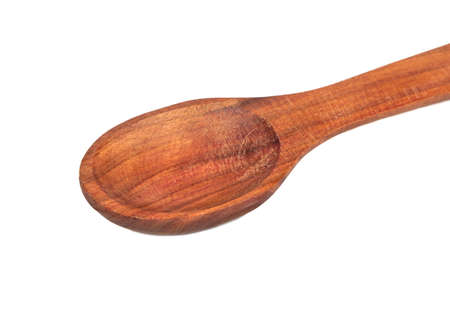 Beautiful wooden spoon closeup isolated on white backgroundの写真素材