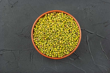 Large bowl with green mung beans on dark background, top viewの写真素材
