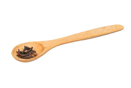 Wooden spoon with dry cloves isolated on white backgroundの写真素材