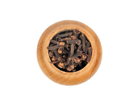 Spice dry cloves in wooden container isolated on white background, top viewの写真素材