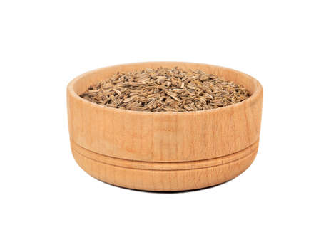 Dry cumin in wooden bowl isolated on white backgroundの写真素材