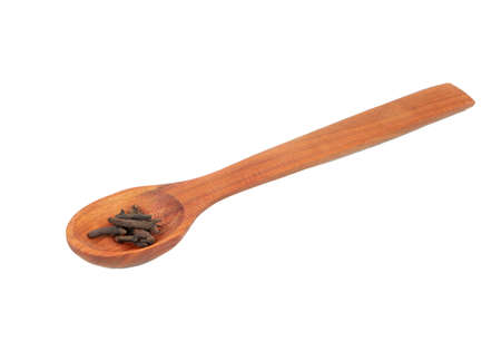 Dry cloves in wooden spoon isolated on white backgroundの写真素材