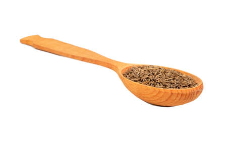 Wooden spoon with dry cumin isolated on white backgroundの写真素材