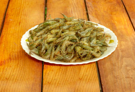 Raw little shrimp in a bowl on the table