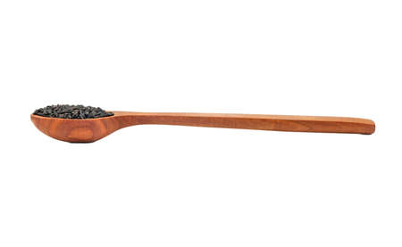 Black sesame seeds in wooden spoon isolated on white backgroundの写真素材