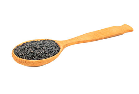 Large wooden spoon with black sesame seeds isolated on white backgroundの写真素材
