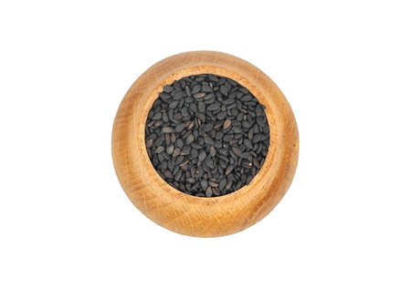 Black sesame in wooden container isolated on white background, top viewの写真素材
