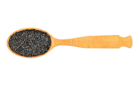 Large wooden spoon with black sesame seeds isolated on white background, top viewの写真素材