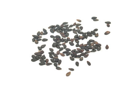 Scattered black sesame seeds on white backgroundの写真素材