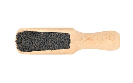 Wooden scoop with black sesame seeds isolated on white backgroundの写真素材