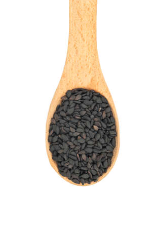 Small spoon with black sesame close up on white background, top viewの写真素材