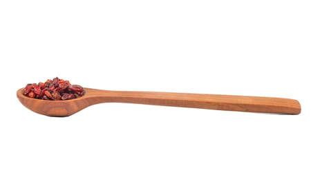 Dry red barberry in wooden spoon isolated on white backgroundの写真素材