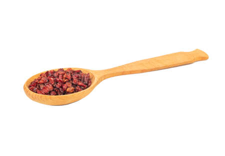 Large wooden spoon with dry barberry berries on white backgroundの写真素材