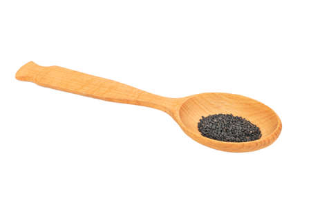 Black sesame seeds in large wooden spoon isolated on white backgroundの写真素材