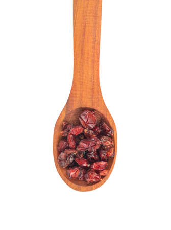 Wooden spoon with dry red barberry on white background, top viewの写真素材