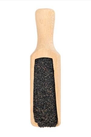 Wooden scoop with black sesame seeds isolated on white backgroundの写真素材