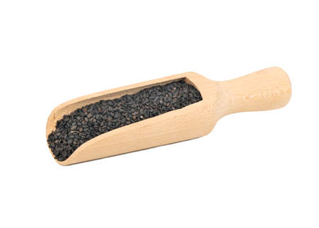 Wooden scoop with black sesame seeds isolated on white backgroundの写真素材