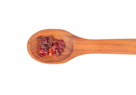 Wooden spoon with dry red barberry on white background close up, top viewの写真素材