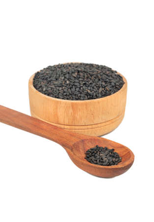 Black sesame in bowl and spoon on white backgroundの写真素材
