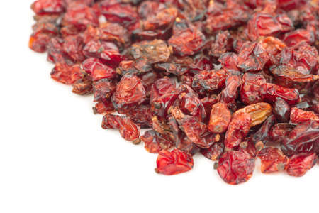 Scattered red berries of dry barberry on a white backgroundの写真素材
