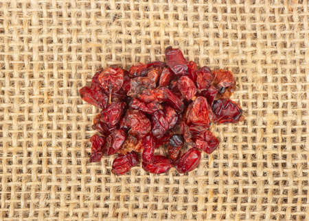 Small pile of dry barberry on the burlap close-up, top viewの写真素材