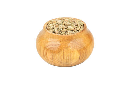 Spice dry fennel in wooden container isolated on white backgroundの写真素材