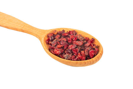 Dry barberry berries in wooden spoon close up on white backgroundの写真素材