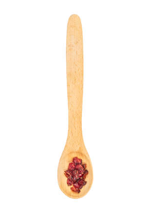 Dry barberry in a small wooden spoon isolated on white background, top viewの写真素材