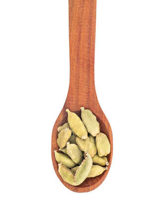 Wooden spoon with dry green cardamom on white background, top viewの写真素材