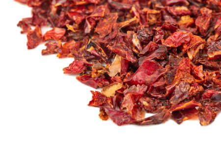 Scattered slices of dry red pepper on a white backgroundの写真素材