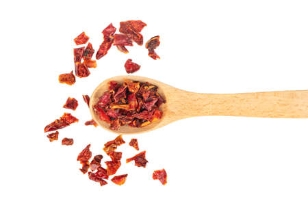 Scattered slices of dry red pepper in a spoon on a white backgroundの写真素材