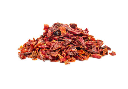 Pile of pieces of dry red pepper on a white backgroundの写真素材