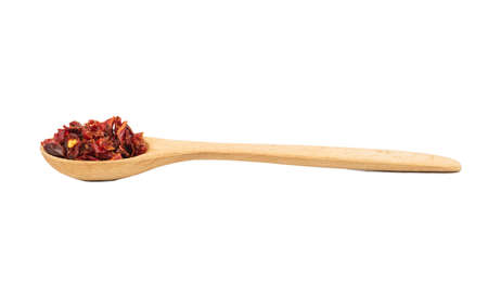 Pieces of dry red pepper in a wooden spoon isolated on a white backgroundの写真素材