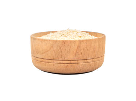 Sesame seeds in wooden bowl isolated on white backgroundの写真素材