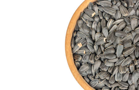 Part of a bowl with sunflower seeds on a white background, top viewの写真素材