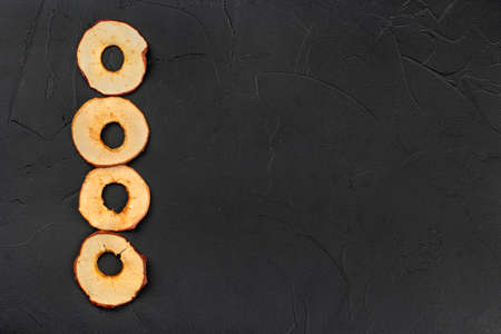 Four dry apple chips on an empty concrete backgroundの写真素材