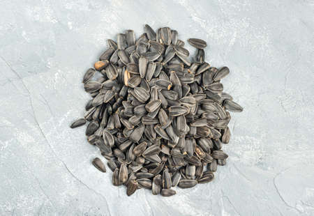 Bunch of sunflower seeds on a light concrete backgroundの写真素材