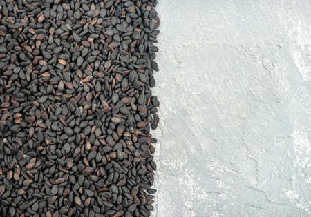 Black sesame on a light concrete background, top viewの写真素材