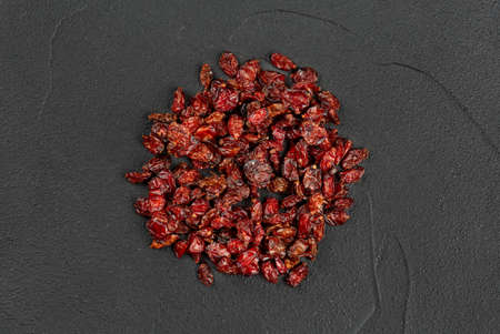 Pile of dry barberry on a dark background, top viewの写真素材