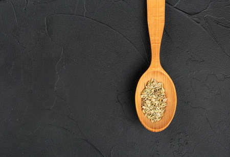 Spoon with dry fennel on empty concrete backgroundの写真素材