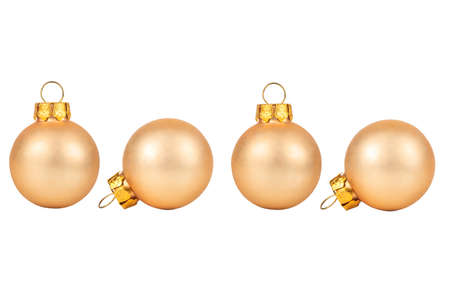 Four beige Christmas balls isolated on white backgroundの写真素材
