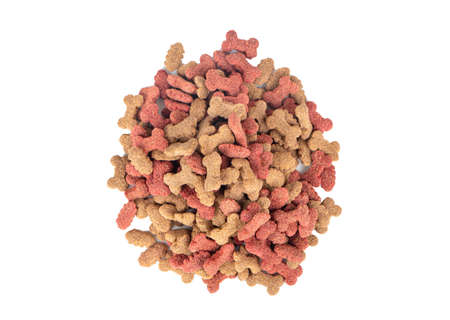 Pile of dry dog food in the shape of a bone on a white background, top viewの写真素材