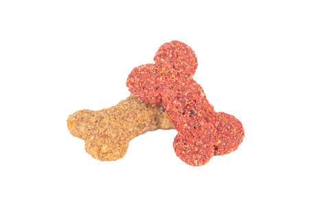 Dry dog food in the shape of a bone on a white backgroundの写真素材
