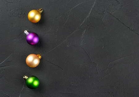 Four colorful Christmas balls on an empty concrete backgroundの写真素材